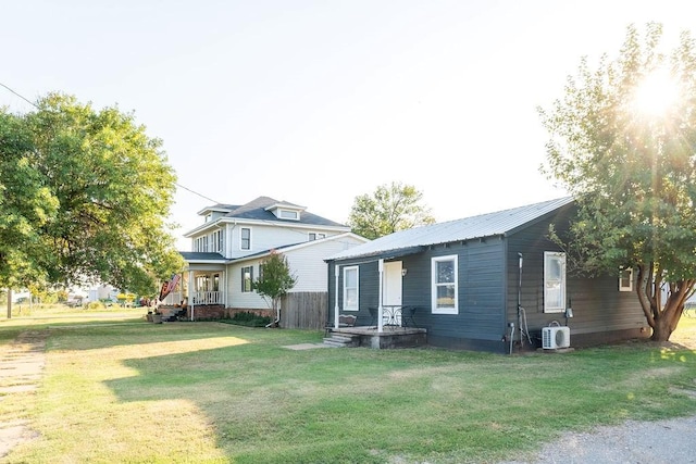 view of front facade with ac unit and a front yard