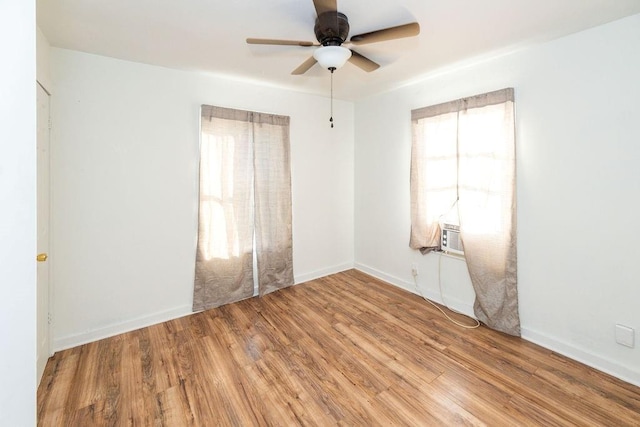 611 Wichita Ave, Devol, OK 73531 - spare room with wood finished floors, a ceiling fan, and cooling unit