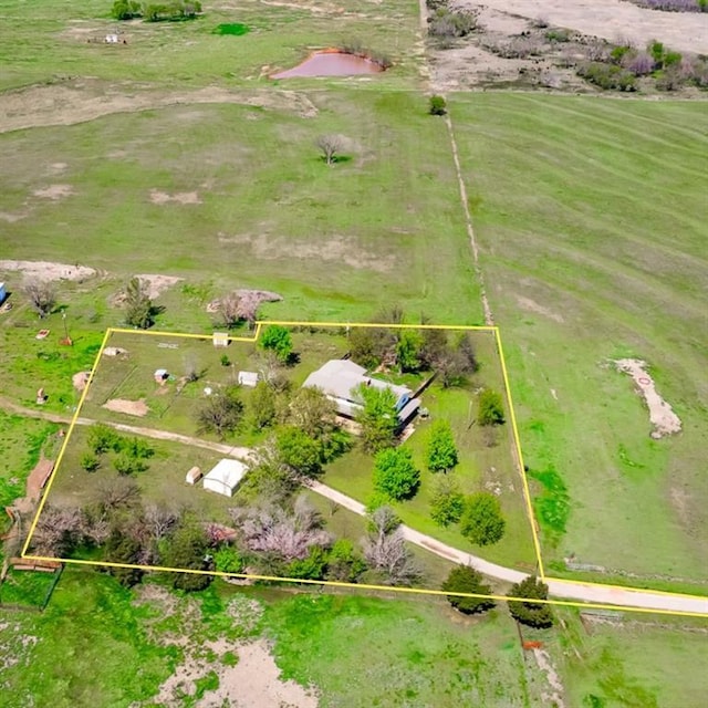 birds eye view of property with a rural view