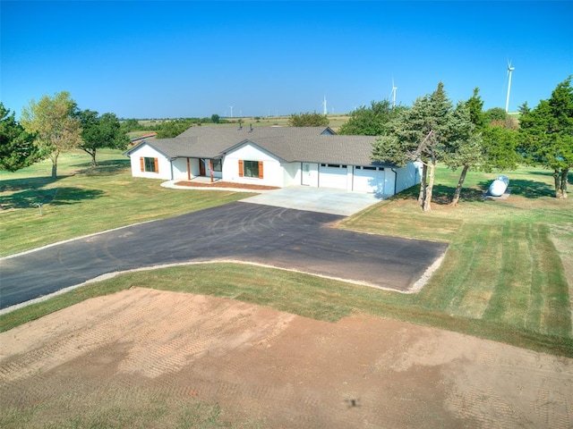 ranch-style home featuring a garage and a front yard