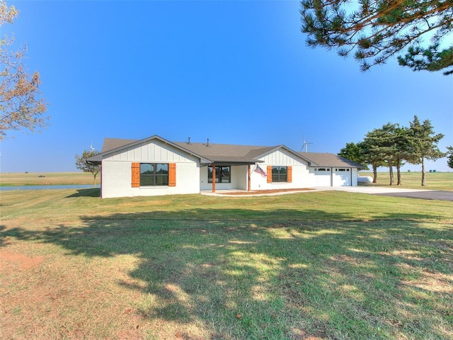 ranch-style house with a garage and a front yard