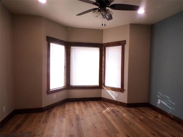 empty room featuring hardwood / wood-style flooring and ceiling fan