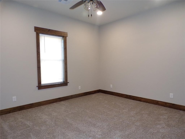 empty room featuring carpet flooring and ceiling fan