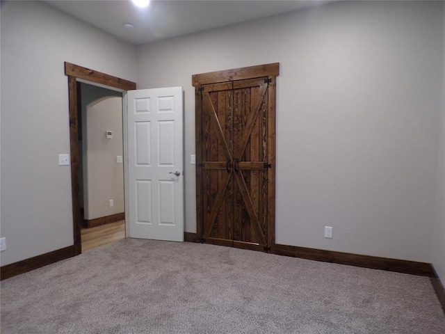 unfurnished bedroom with light colored carpet