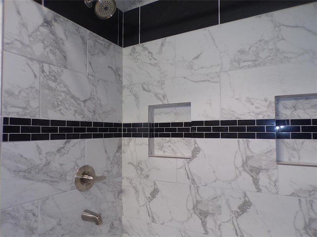 interior details with tiled shower / bath combo