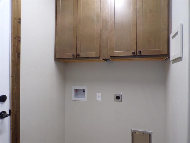 clothes washing area featuring hookup for a washing machine, cabinets, and hookup for an electric dryer