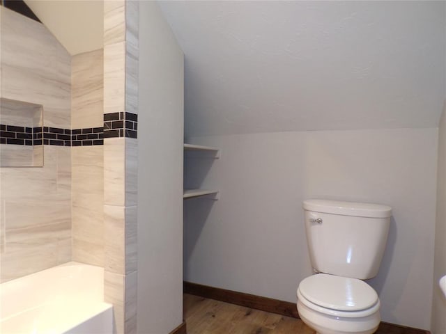 bathroom with hardwood / wood-style flooring, toilet, and lofted ceiling