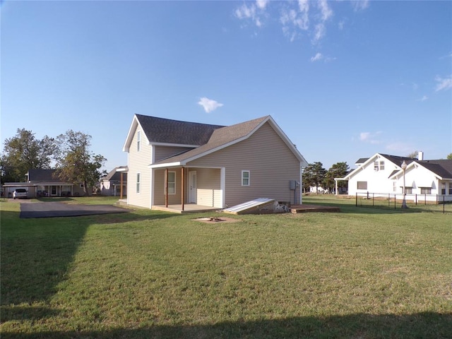 back of property with a patio area and a yard