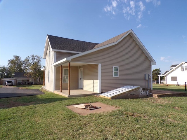 back of property featuring a yard