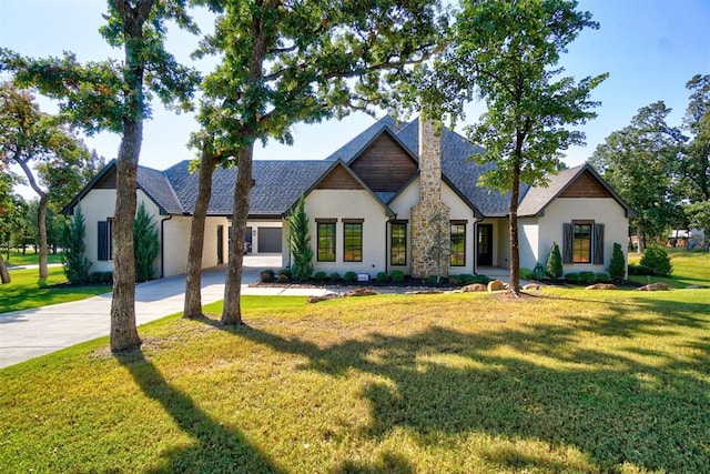 view of front of house featuring a garage and a front lawn