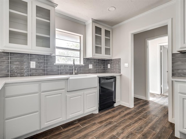 kitchen featuring white cabinets, black dishwasher, ornamental molding, and dark wood-type flooring