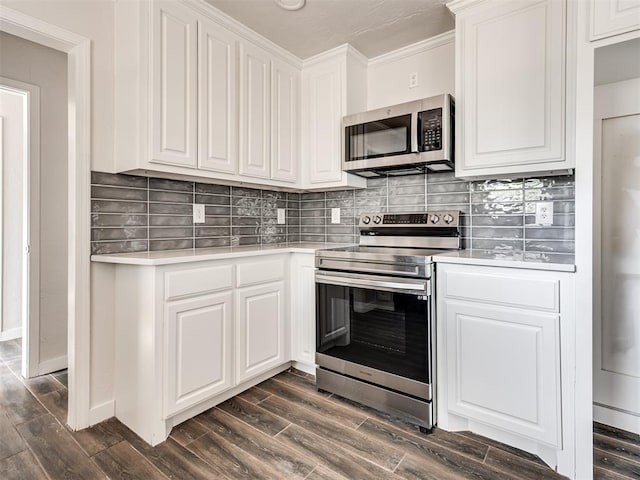 kitchen featuring white cabinets, stainless steel appliances, and dark wood-type flooring