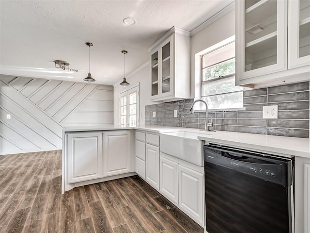 kitchen with dark wood-type flooring, white cabinets, a healthy amount of sunlight, and black dishwasher