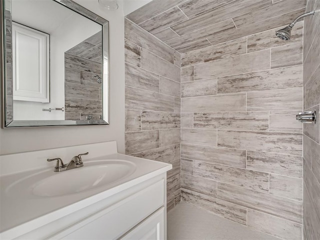 bathroom featuring vanity and tiled shower