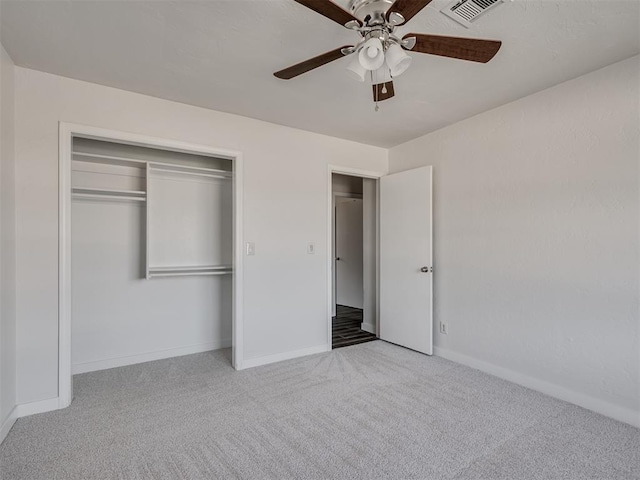 unfurnished bedroom with light carpet, a closet, and ceiling fan