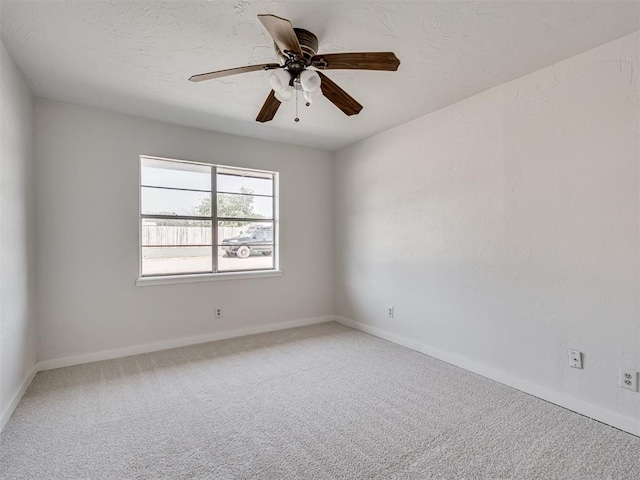 spare room featuring carpet and ceiling fan