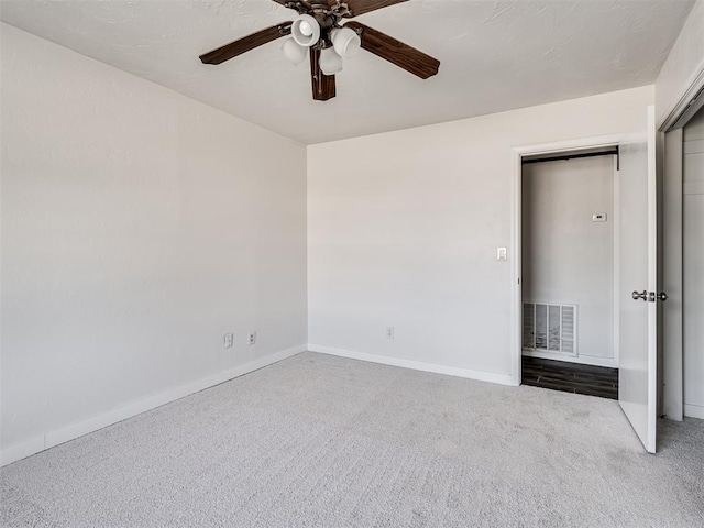 unfurnished bedroom with carpet flooring, a closet, and ceiling fan