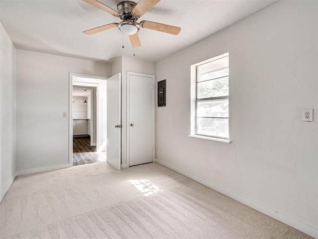 unfurnished bedroom featuring ceiling fan and carpet