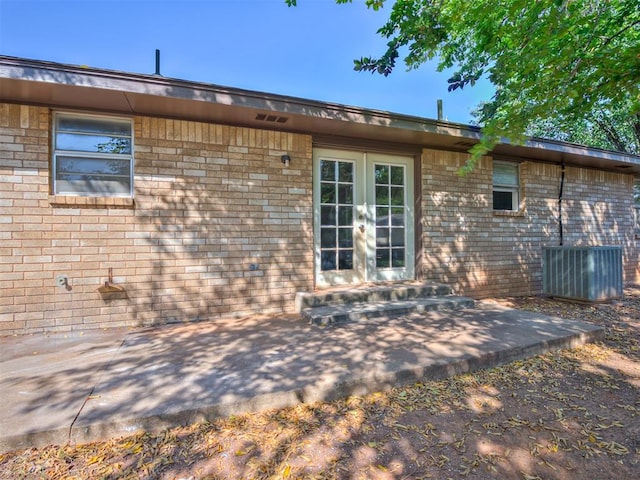 back of house with french doors, a patio, and central AC