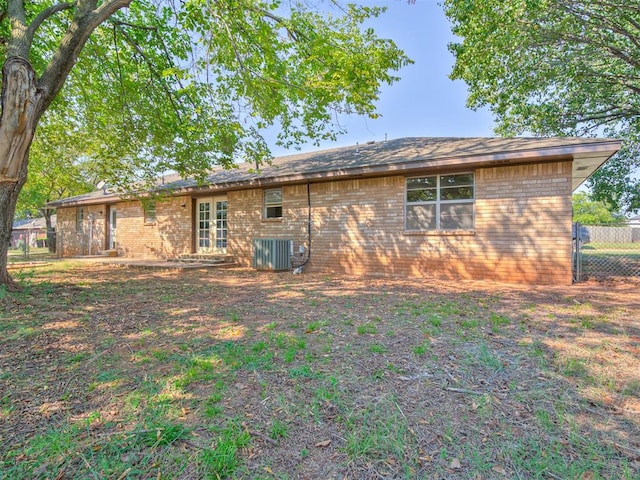 back of property featuring french doors and central air condition unit