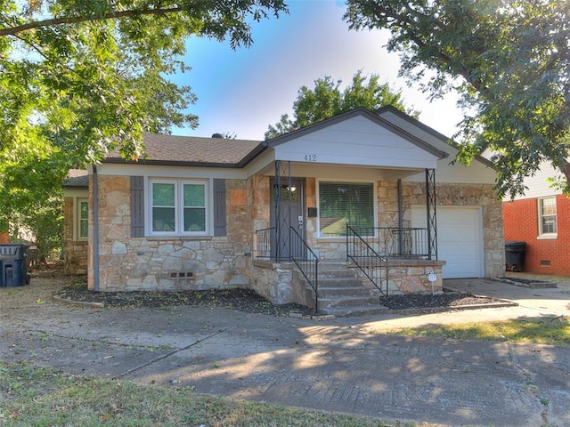 view of front of home featuring a porch and a garage