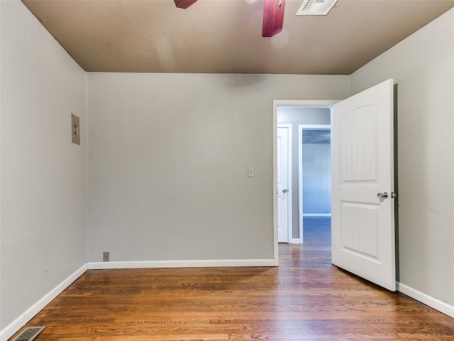 empty room featuring ceiling fan and wood-type flooring