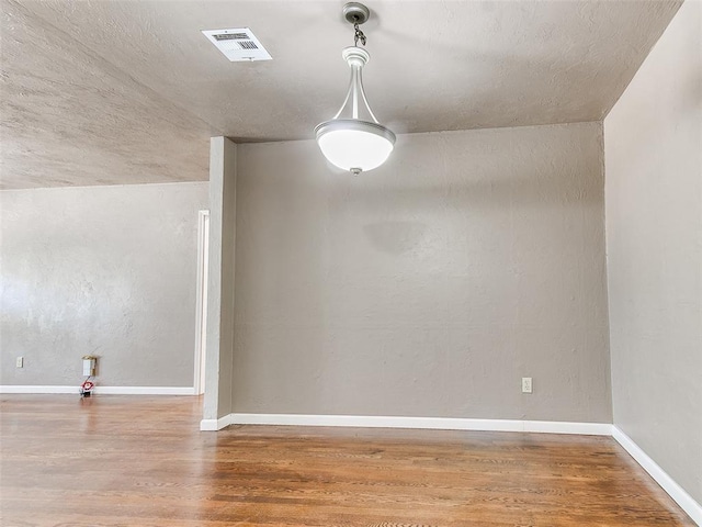 unfurnished dining area featuring hardwood / wood-style floors