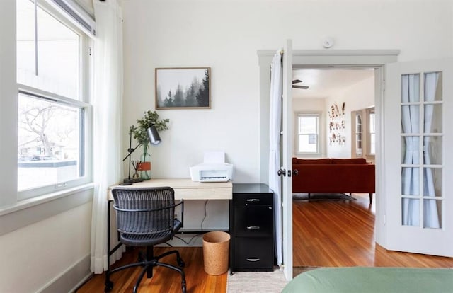 office area featuring ceiling fan, plenty of natural light, hardwood / wood-style floors, and french doors