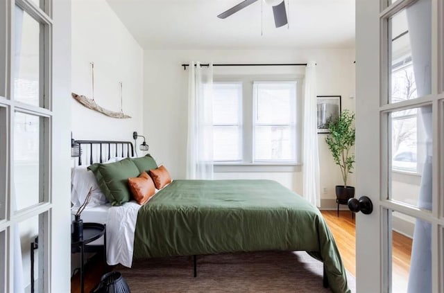 bedroom with hardwood / wood-style floors and ceiling fan