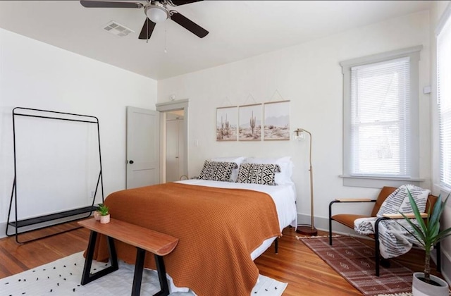 bedroom with hardwood / wood-style floors and ceiling fan