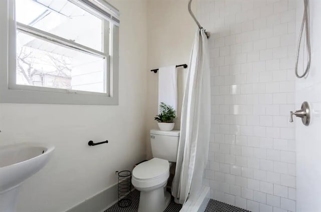 bathroom with tile patterned flooring, a shower with shower curtain, and toilet