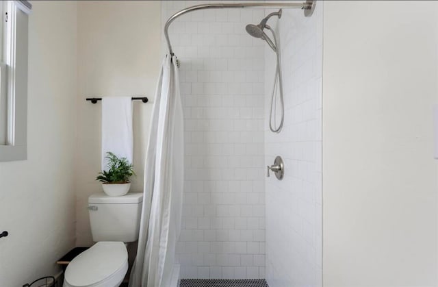 bathroom with a shower with curtain and toilet