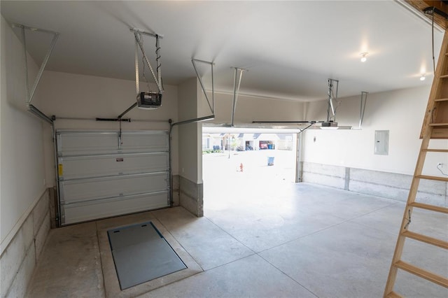garage with electric panel and a garage door opener