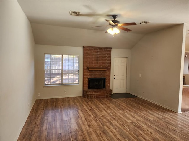 unfurnished living room featuring wood-type flooring, a brick fireplace, ceiling fan, and lofted ceiling