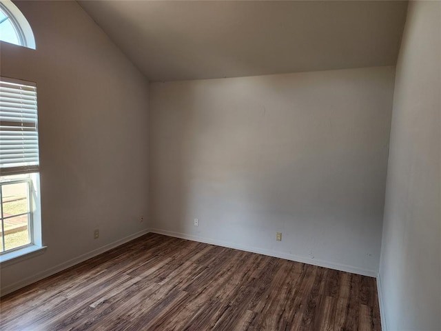 empty room featuring hardwood / wood-style floors and lofted ceiling