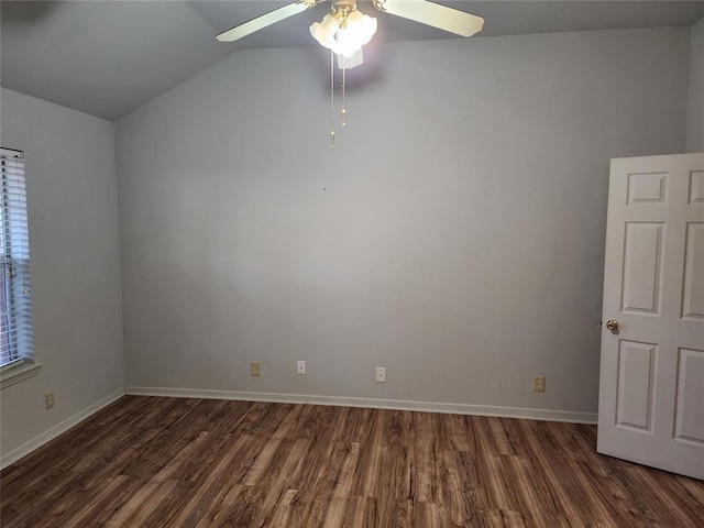 empty room featuring dark hardwood / wood-style floors, vaulted ceiling, and ceiling fan