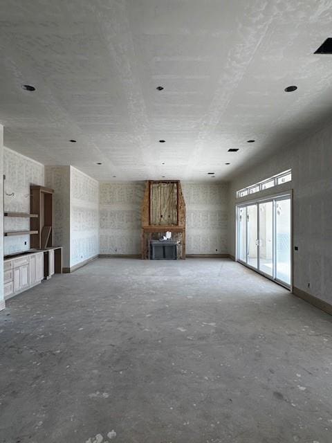 unfurnished living room with concrete floors