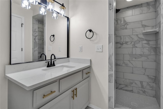 bathroom with vanity and a tile shower