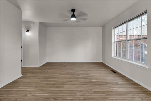 empty room featuring ceiling fan and light wood-type flooring