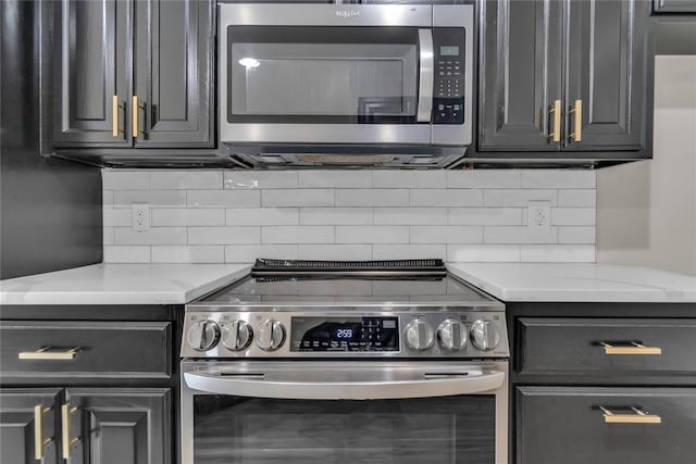 kitchen featuring tasteful backsplash, light stone counters, and stainless steel appliances