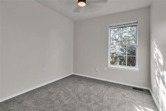 unfurnished room featuring ceiling fan and carpet floors