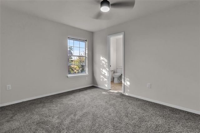 spare room with ceiling fan and carpet