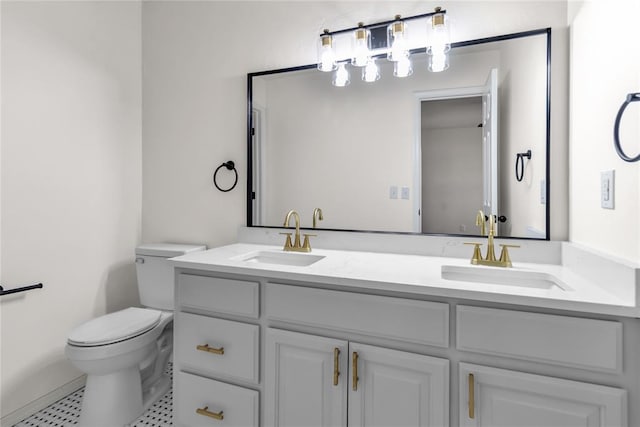 bathroom with tile patterned flooring, vanity, and toilet