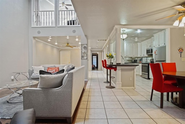 tiled living room featuring ornamental molding and sink