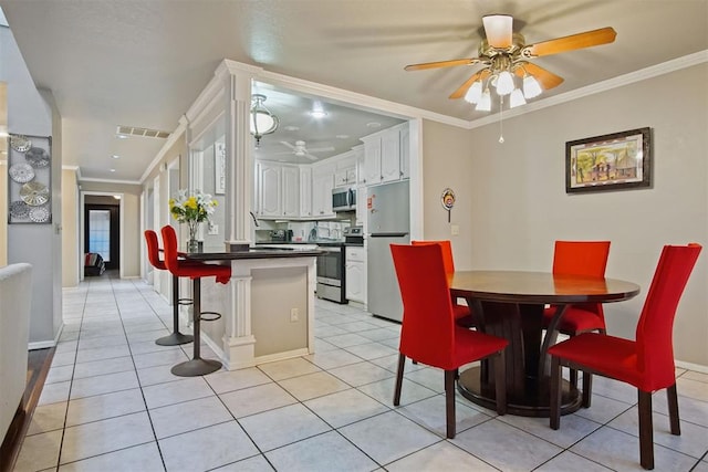 dining area with ceiling fan, light tile patterned flooring, and crown molding