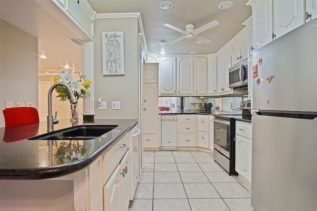 kitchen with stainless steel appliances, ceiling fan, sink, white cabinetry, and light tile patterned flooring