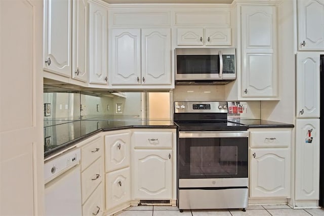 kitchen featuring stainless steel appliances, light tile patterned floors, and white cabinetry