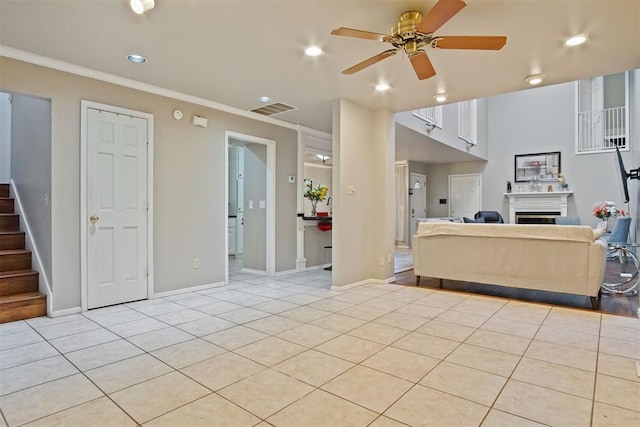 tiled living room featuring ornamental molding and ceiling fan