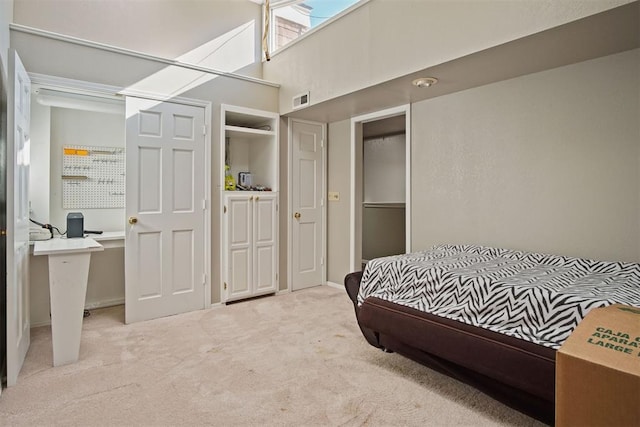 bedroom featuring a high ceiling and light colored carpet