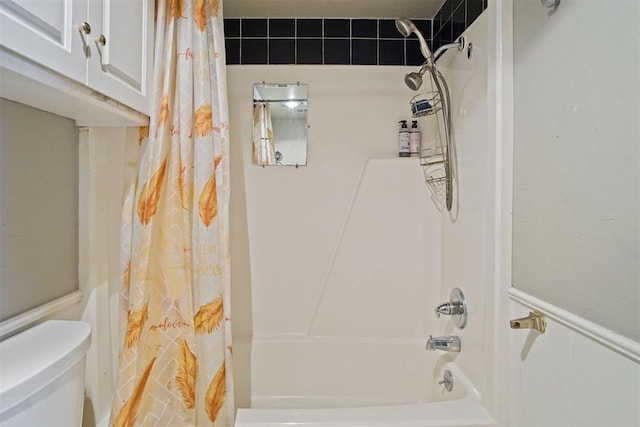 bathroom with toilet and shower / bathtub combination with curtain